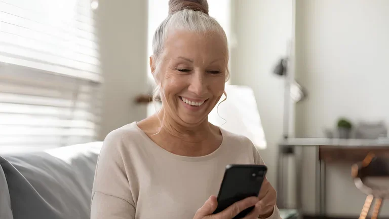 Lächelnde Seniorin am Smartphone