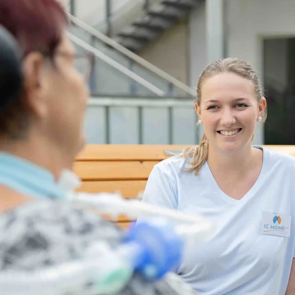 Pflegerin im Garten mit Patientin